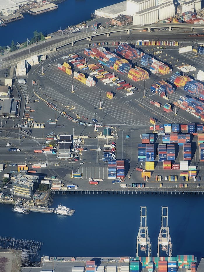 About Overhead view of a bustling port with colorful shipping containers and waterfront area.
