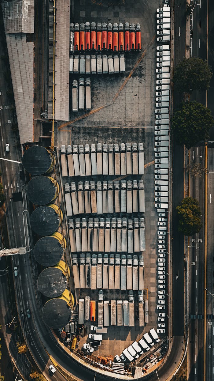 Services Bird's-eye view of an industrial area with neatly parked trucks, showcasing organization and infrastructure.